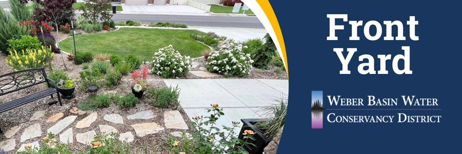 Front Yard. A small round lawn surrounded by flower beds, shrubs and a flagstone path. Weber Basin Water Conservancy District